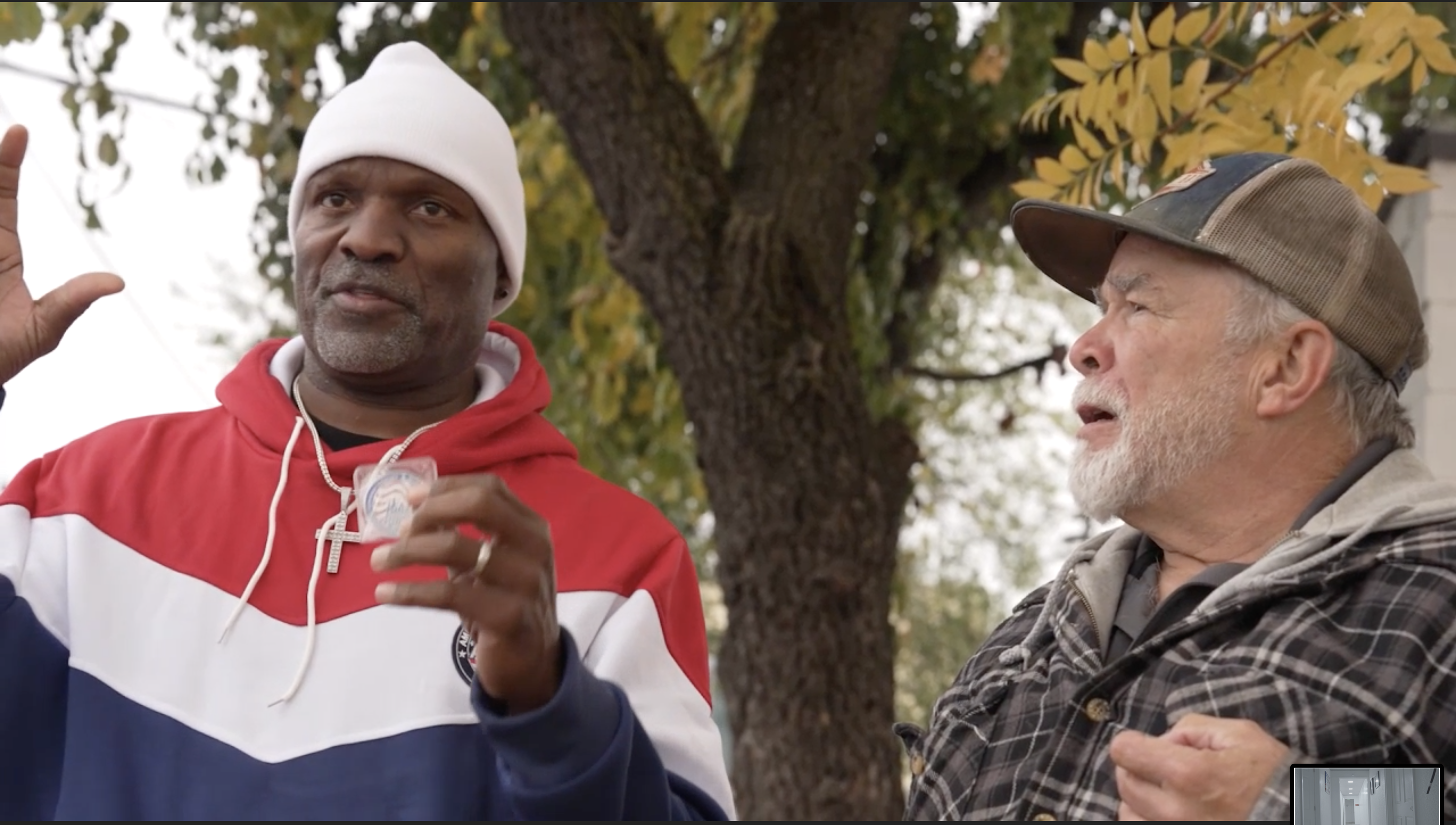 Ralpheal in conversation with Randall outdoors
